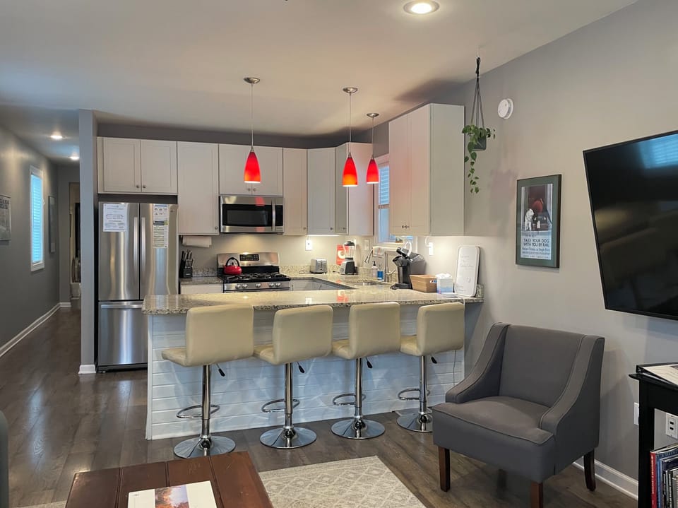 Living room open to eat-at kitchen counter with 4 adjustable stools