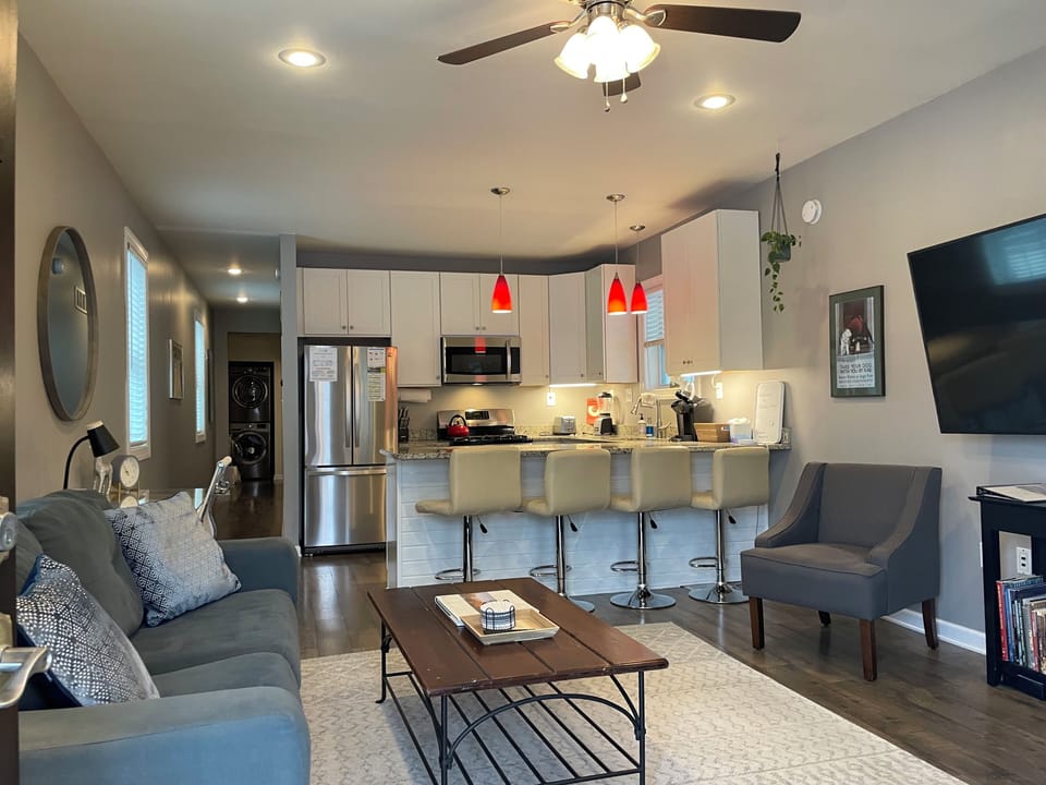 Living room open to eat-at kitchen counter with 4 adjustable stools