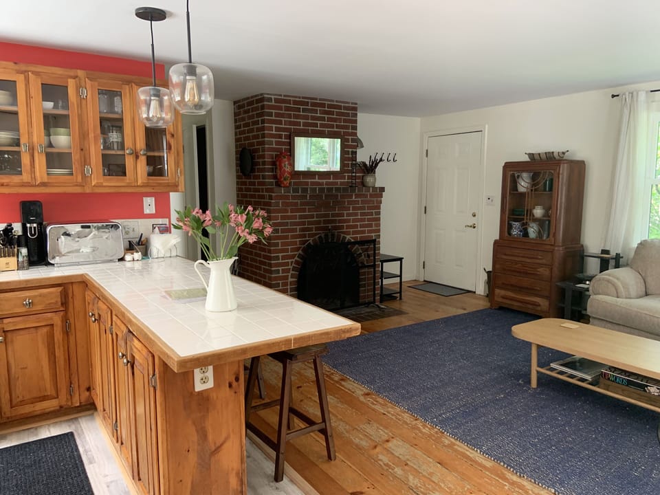 Brick fireplace and sitting area seen from kitchen