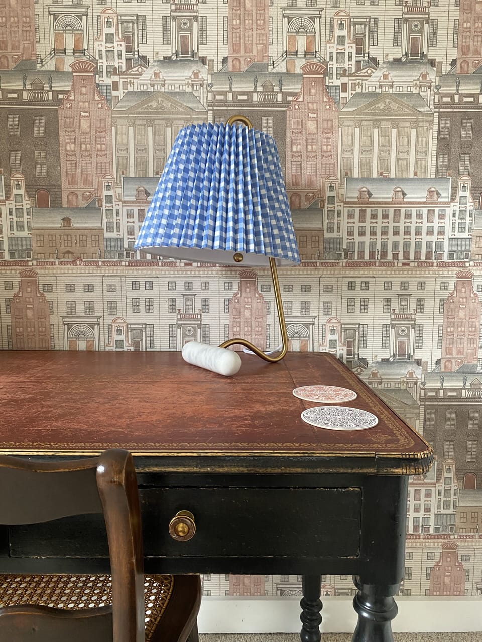 Cozy work space with desk, chair, and lamp