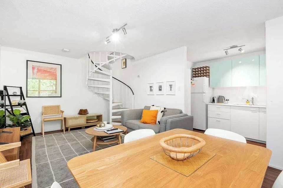 Enjoy the view encompassing the open dining area, well-equipped kitchen, and comfortable living room, designed for seamless interaction and relaxation.
