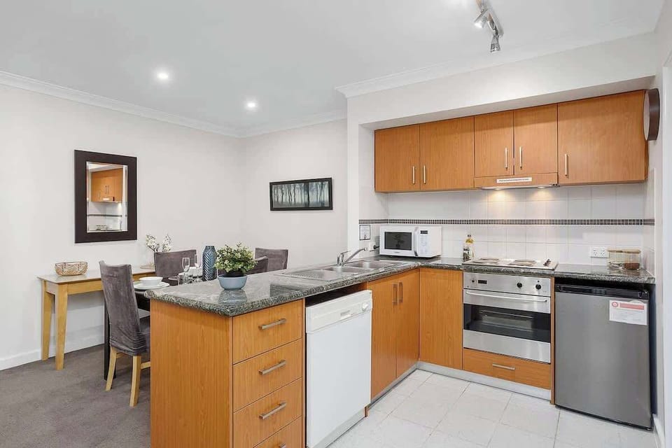 Savor the convenience of a fully equipped kitchen, complete with a dishwasher for easy cleanup, a microwave for quick meals, an electric stovetop and oven for cooking, and ample kitchen cabinets for storage.