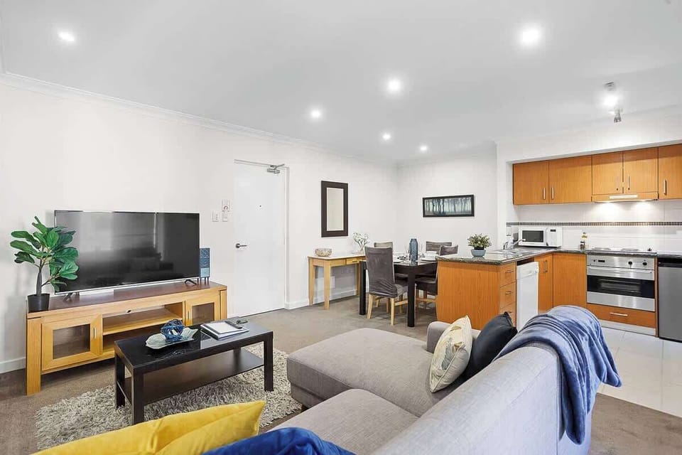 Enjoy the best of both worlds in our open and inviting apartment. From relaxing on the sofa to preparing meals in the full kitchen and dining together at the table, this space is designed for your comfort and convenience.