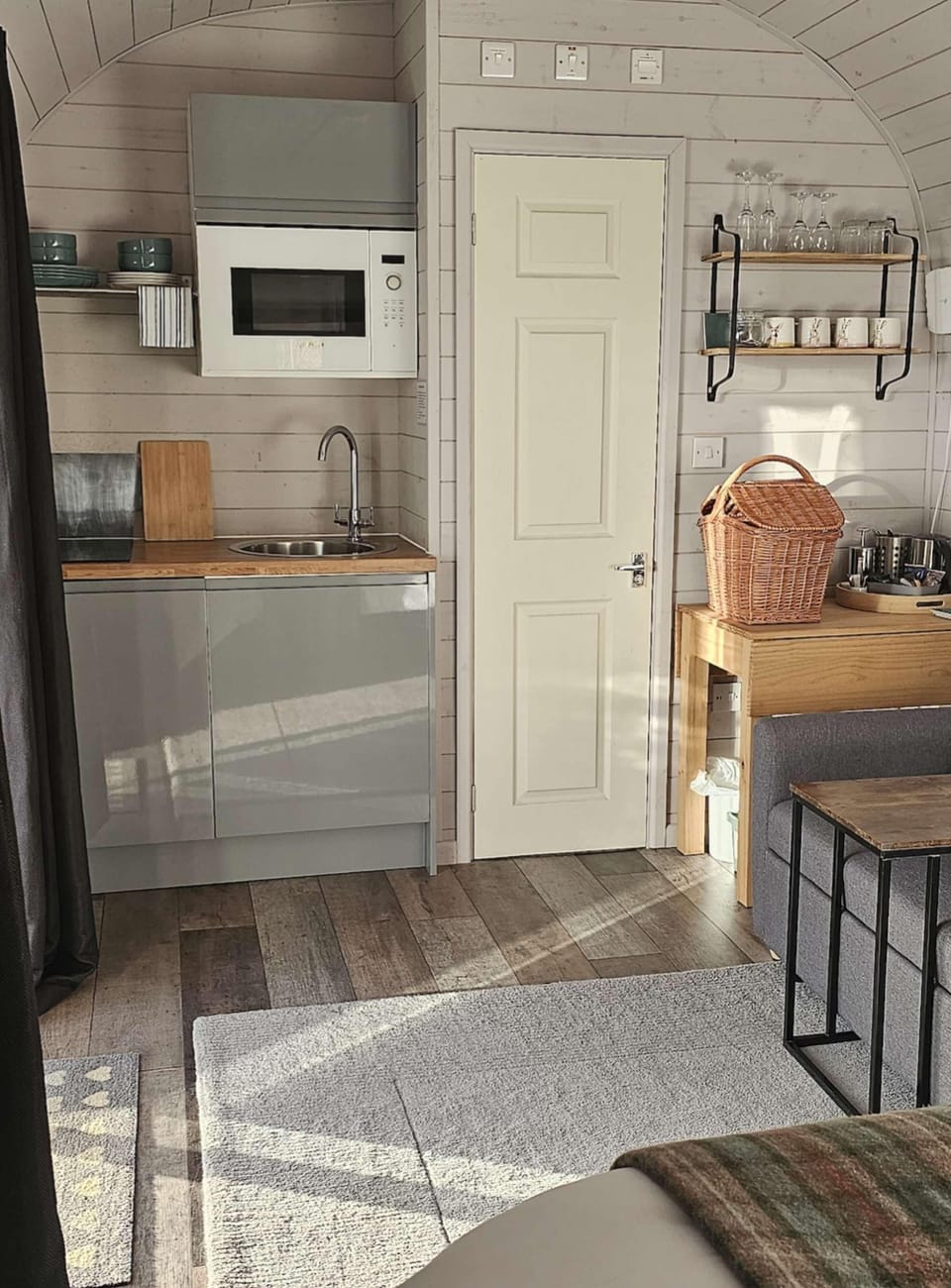 The kitchen area comes equipped with a two-ring induction hob, microwave, toaster, kettle, fridge freezer, crockery, cuttlery, cooking utencils, pots and pans.