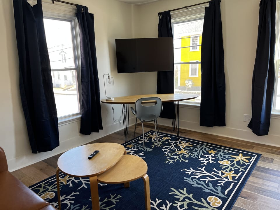 1st Floor Office, Desk/Chair. 50” TV, futon, large closet. Street facing
