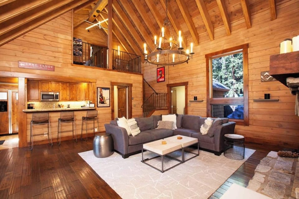 Open concept living room with a large comfy couch, Smart TV, 2 Sonos Speakers, and fireplace! 