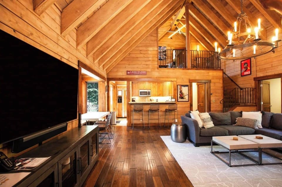 Open concept living room with a large comfy couch, Smart TV, 2 Sonos Speakers, and fireplace! 
