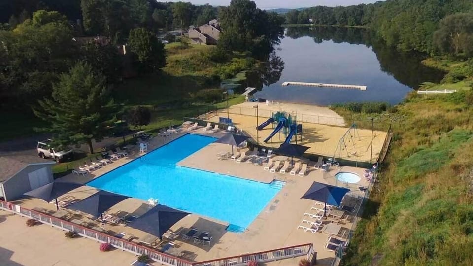 Mill Pond pool next to playground and beach with access to kayaks, paddleboards and canoes. 