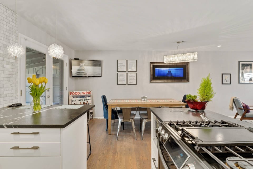 The kitchen is next to the dinning area and wide screen TV.