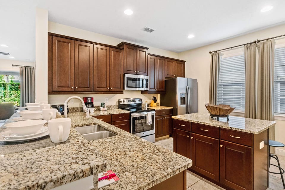 Spacious Kitchen of the Home in Kissimmee Florida - Unleash Your Culinary Creativity - Functional layout designed for efficient meal preparation - Integrated appliances for a seamless and stylish appearance