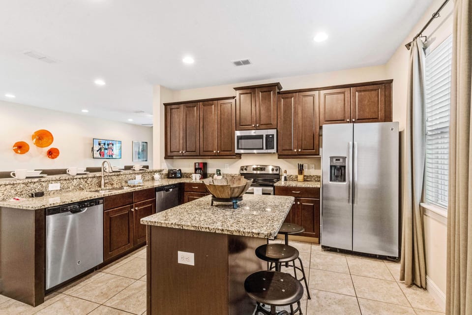Lofty Kitchen of the Home in Kissimmee Florida - Fully Equipped Kitchen  - Granite Counters, Stainless Steel Appliances - Breakfast bar with High Chairs
