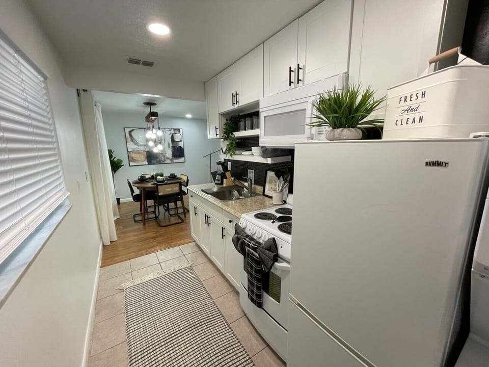 Good size fridge for all your needs located next to the dining room. 