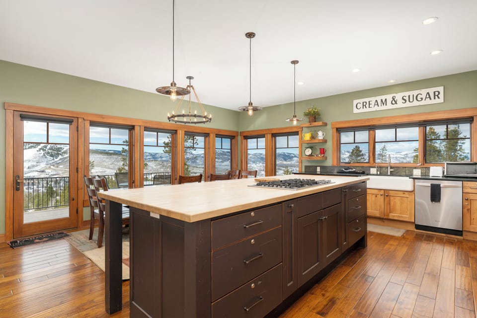 Large butcher block countertop with 5 stools
