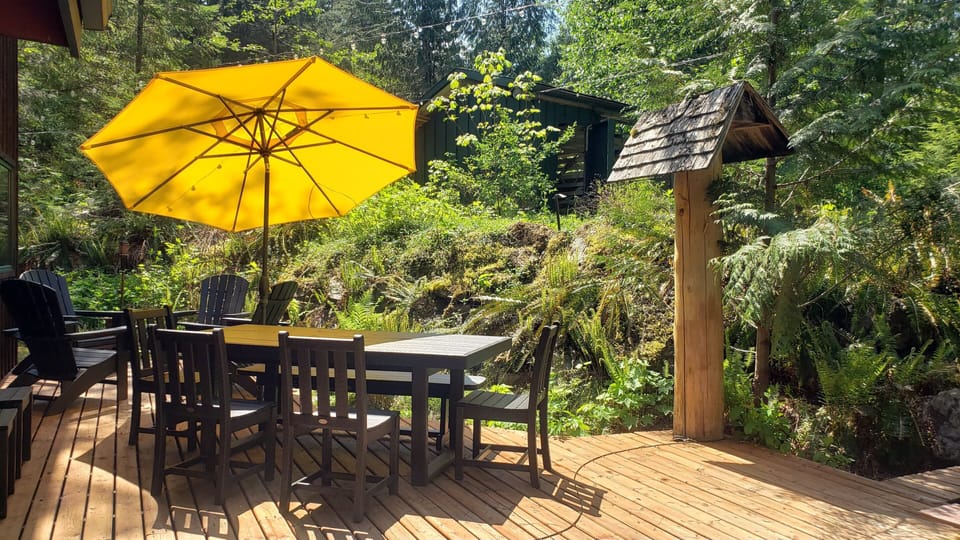 Fully private rear deck with lounge chairs, dining for 8 and the hot tub.