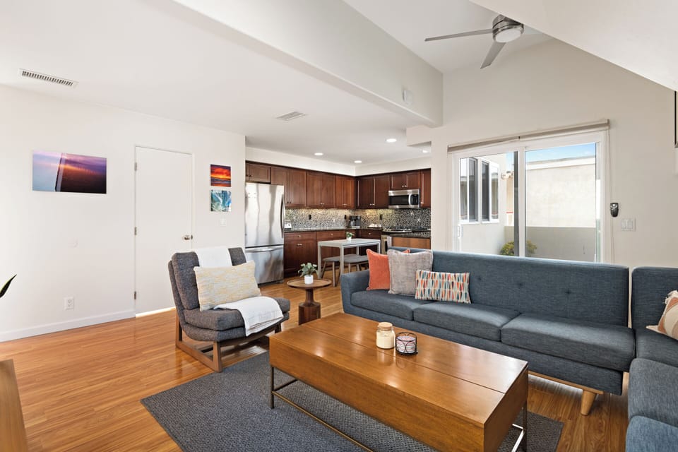 Spacious living room featuring comfortable seating, modern decor, and ample natural light