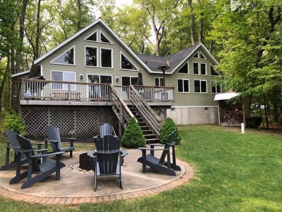 Backyard view of the home - Backyard view of home from the Lake Frontage showing firepit with seating and deck