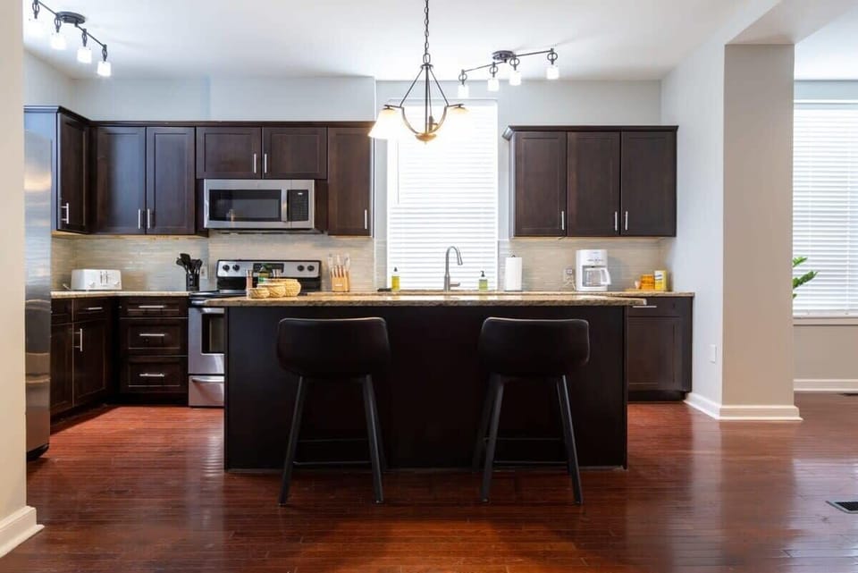 Cooking up a storm in this stunning kitchen. Book your stay now and make unforgettable memories! #VacationVibes