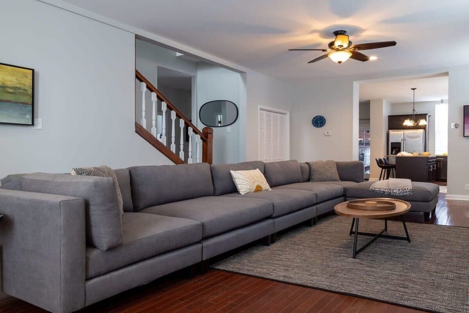 Our cozy living room, featuring a chic gray couch and a sleek coffee table, is the perfect spot to unwind after a day of exploring. #HomeAwayFromHome