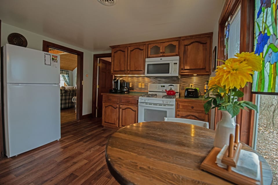 Kitchen with oven, keurig, stocked with dishes and silverware, and more