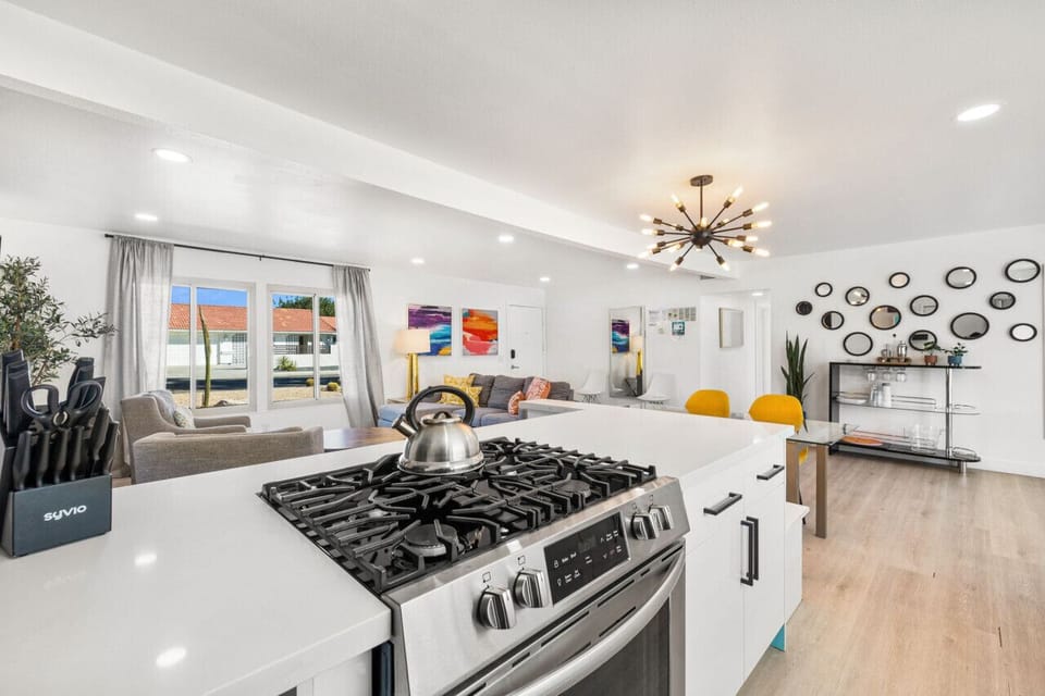 Bright, open kitchen w/ a spacious island and modern range, flowing seamlessly into the living & dining area for easy gathering.