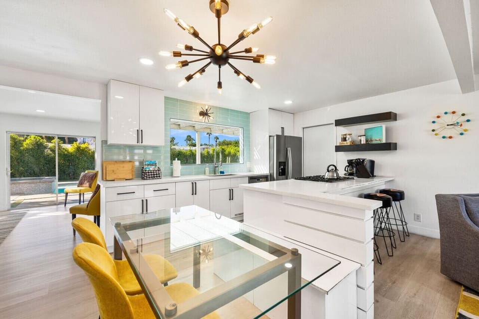 Bright kitchen & dining setup w/ modern finishes, bar seating, & room to gather.