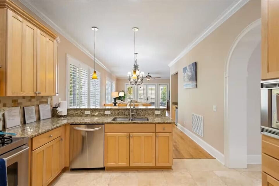 Kitchen looking toward dining room, living room and the covered attached patio.