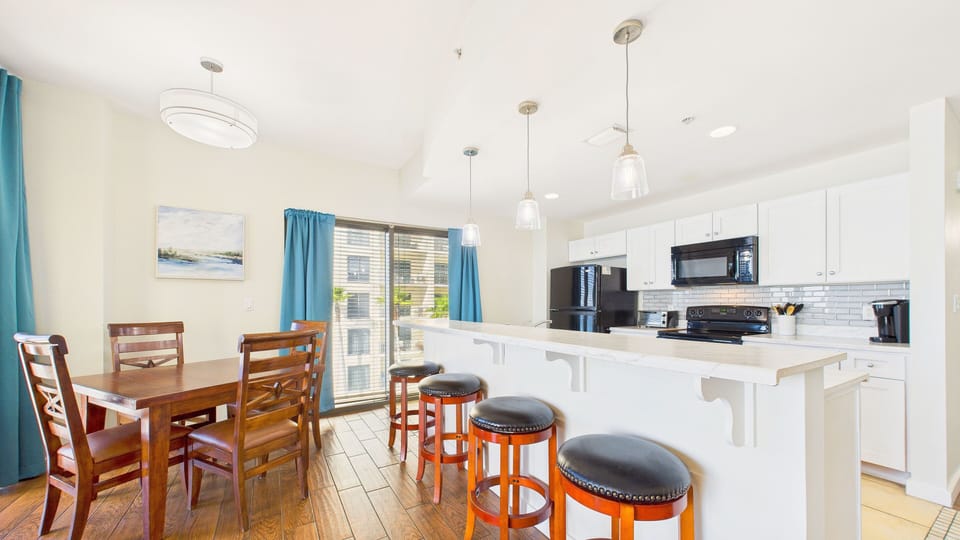 Full kitchen with island + breakfast bar and dining area with seating for 8