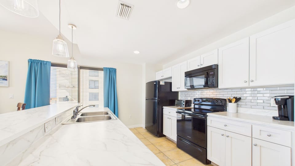 Fully equipped kitchen with toaster oven, coffee essentials, and all the other cooking essentials