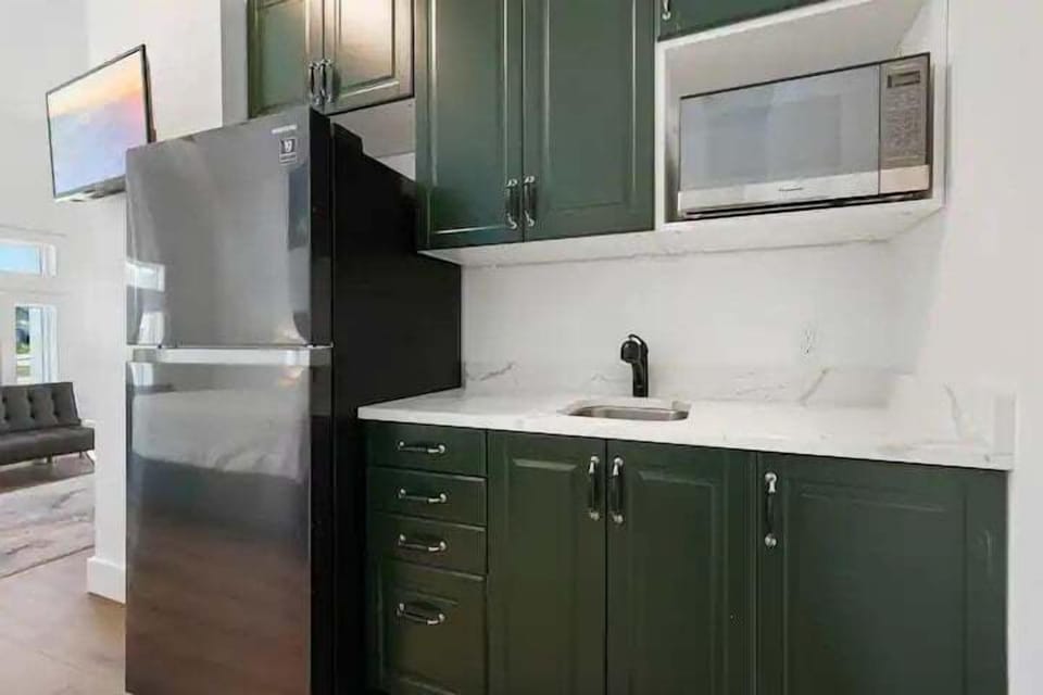 kitchenette with microwave and refrigerator
