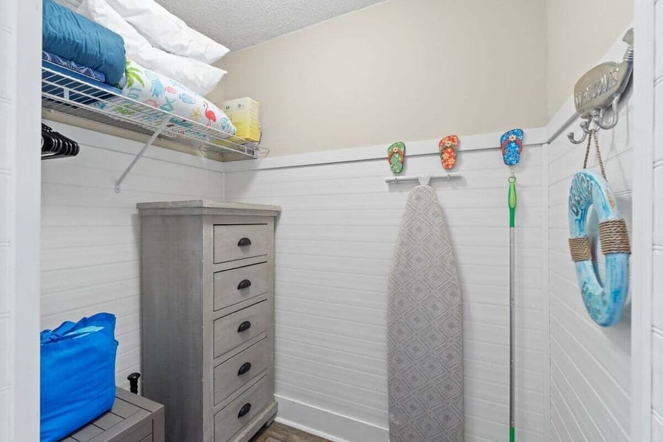 ironing board, towels and bedding