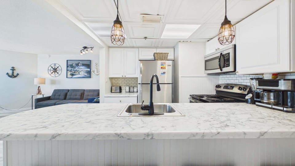 Fully applianced kitchen with all the cooking essentials. Breakfast bar seating additionally on counter.