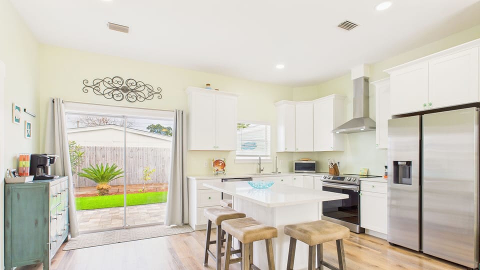 Full kitchen with island along with direct backyard access from the sliding glass doors