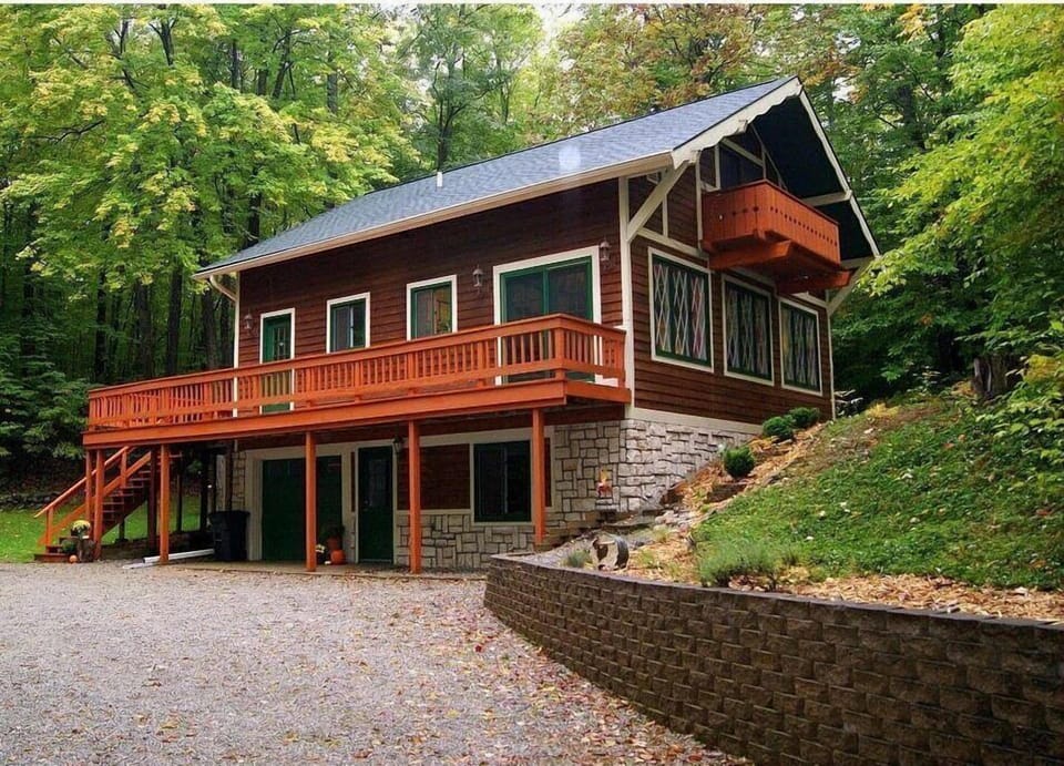 Nestled in the woods between two empty lots, feel the isolation of being in the forest while being minutes from golfing, restaurants, and downtown