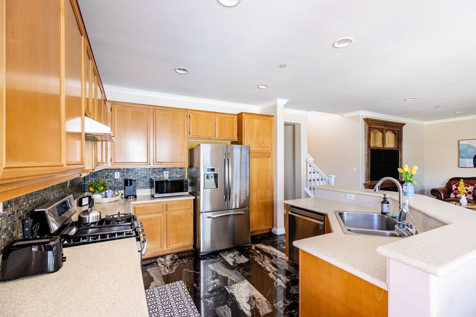 Fully furnished kitchen with stainless steel appliances
