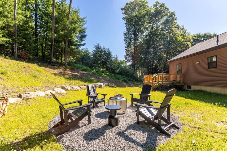 Smokeless wood stove fire pit and adirondack chairs