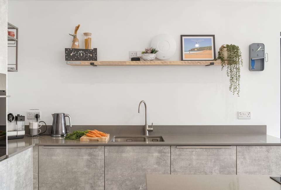 The modern kitchen is beautifully furnished with subtle colours