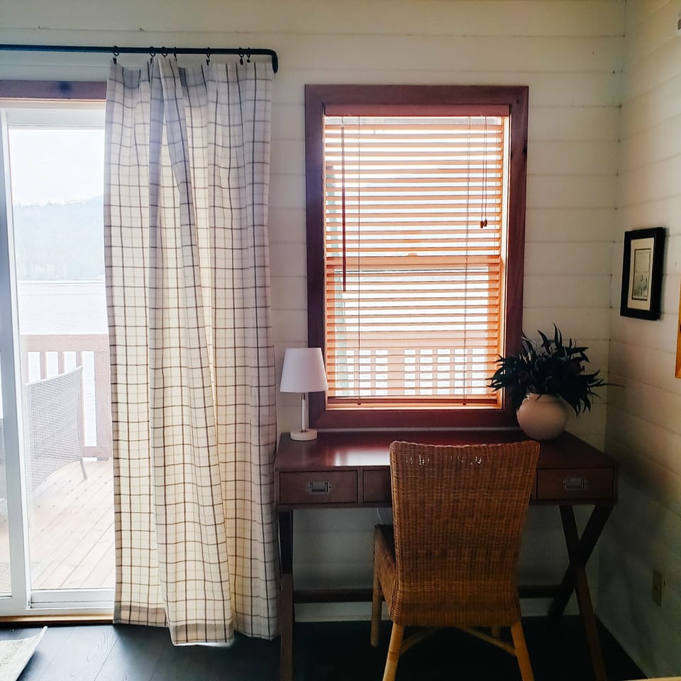 Primary bedroom with a queen bed, desk, reading nook, and a closet with dresser