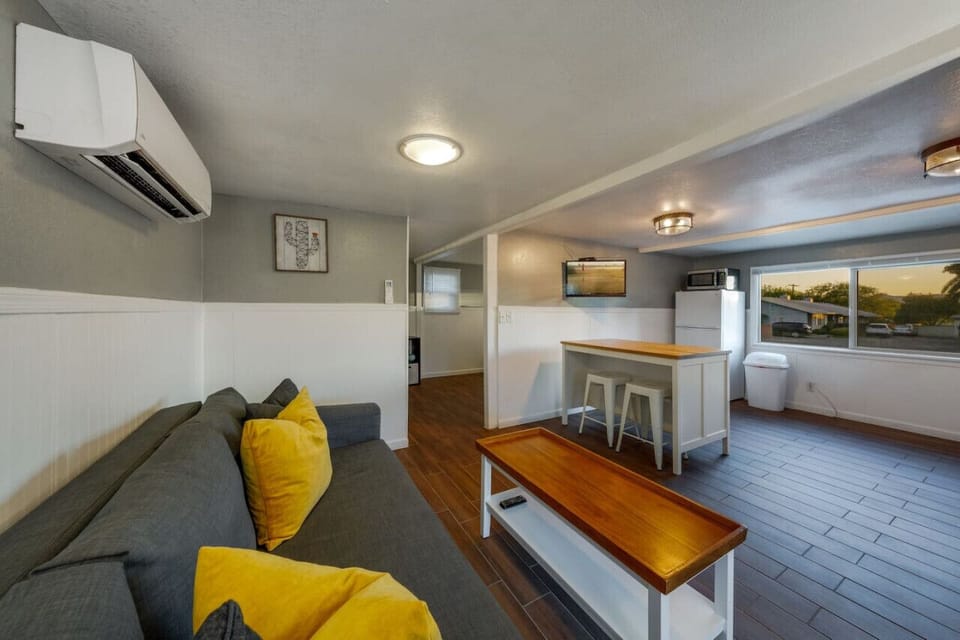 Living room space with view of kitchen and front of house
