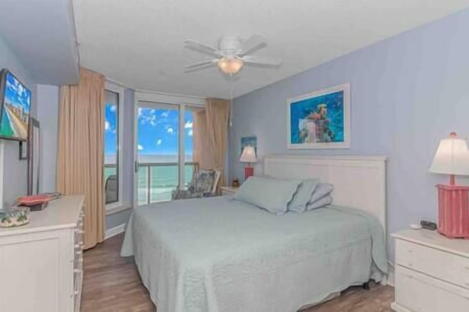 Master bedroom with king-size bed includes ocean views, direct balcony access and adjacent bathroom!