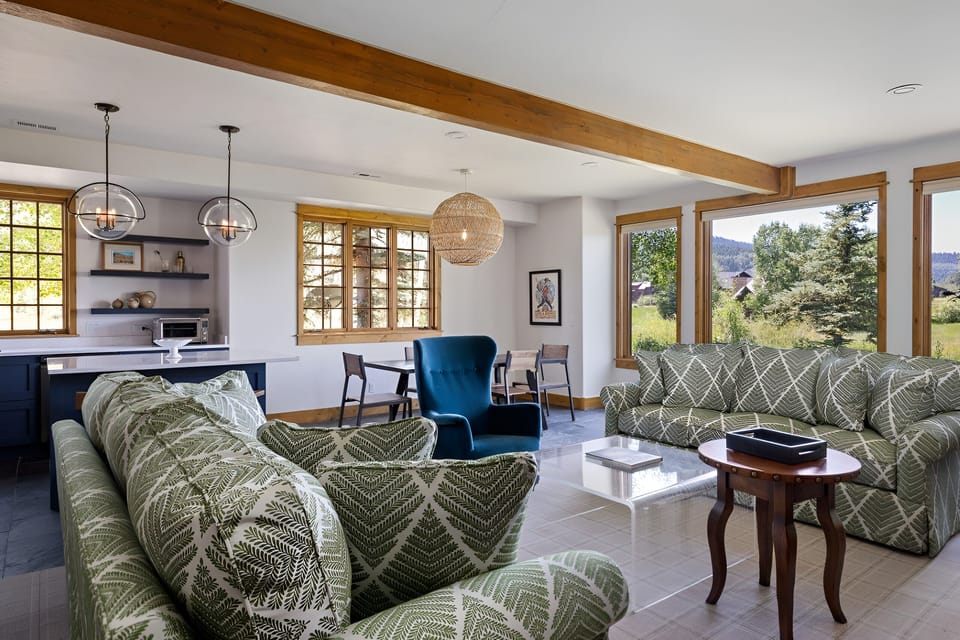 Relax in the airy lounge with peaceful mountain-view windows.
