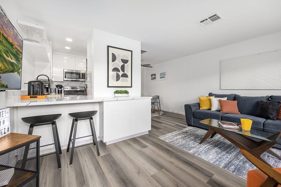 - Sleek Palm Springs bar area with stools and easy access to the modern kitchen   - Enjoy morning coffee or evening wine while watching the smart TV   - Open design blends dining and living for the perfect desert escape