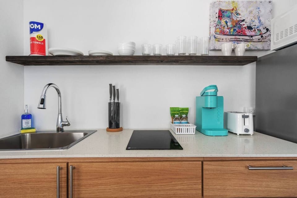 Prepare meals in this well-equipped kitchen with a refrigerator and microwave.