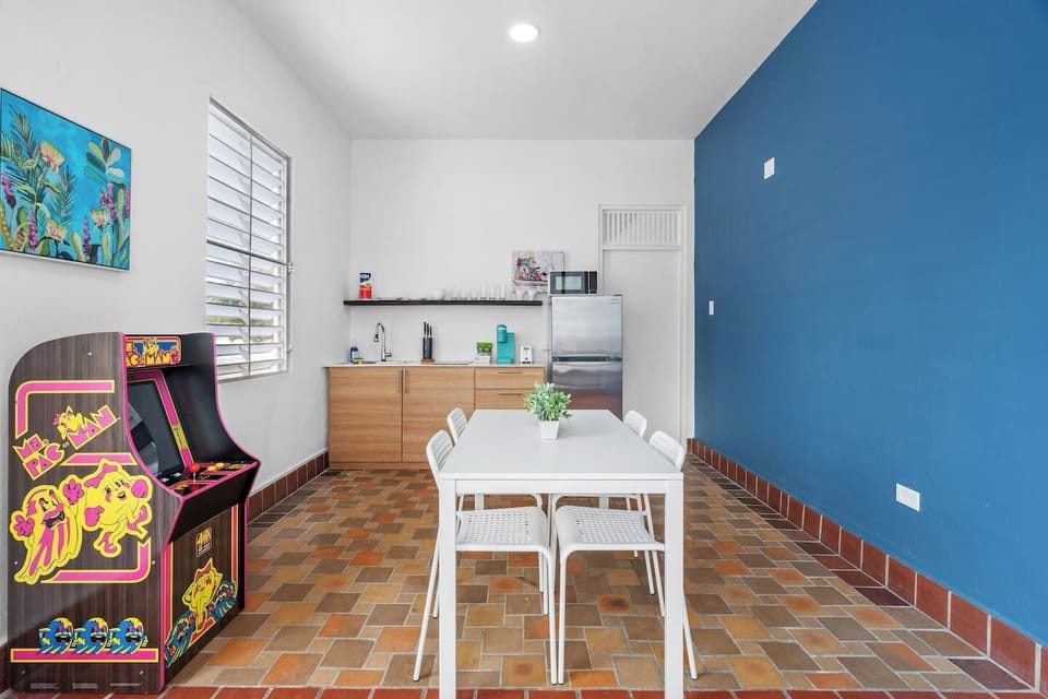 Step into a room designed for relaxation or productivity, enhanced by the presence of an arcade machine.