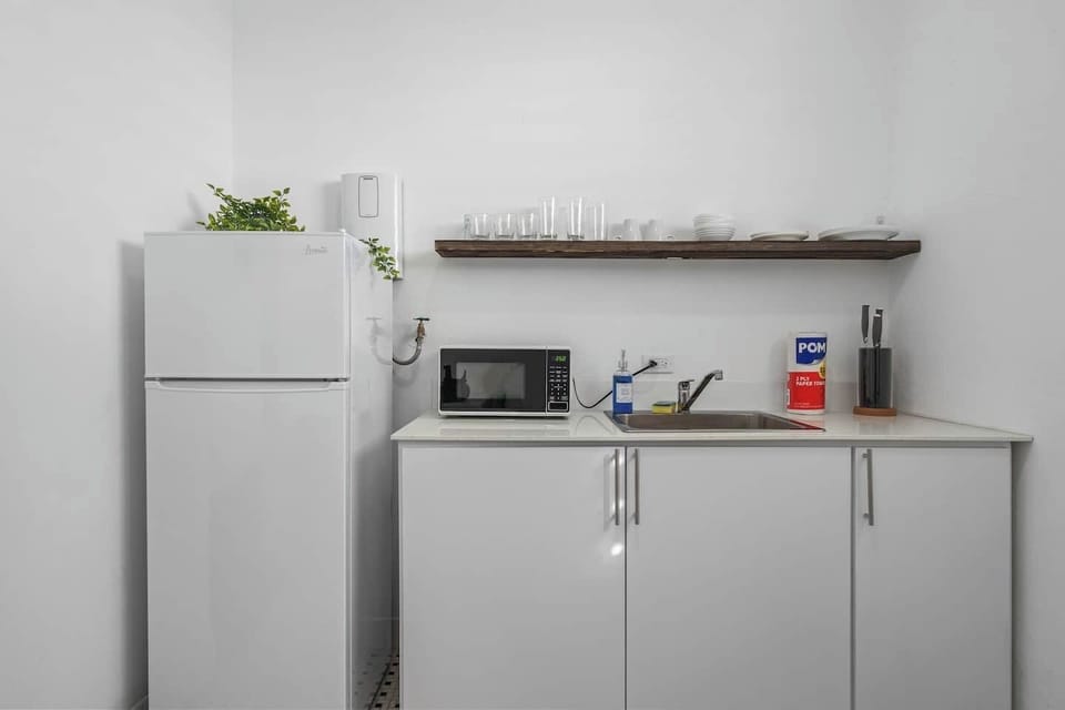 Discover culinary inspiration in our sleek white kitchen, where modern design meets functionality for your cooking pleasure.