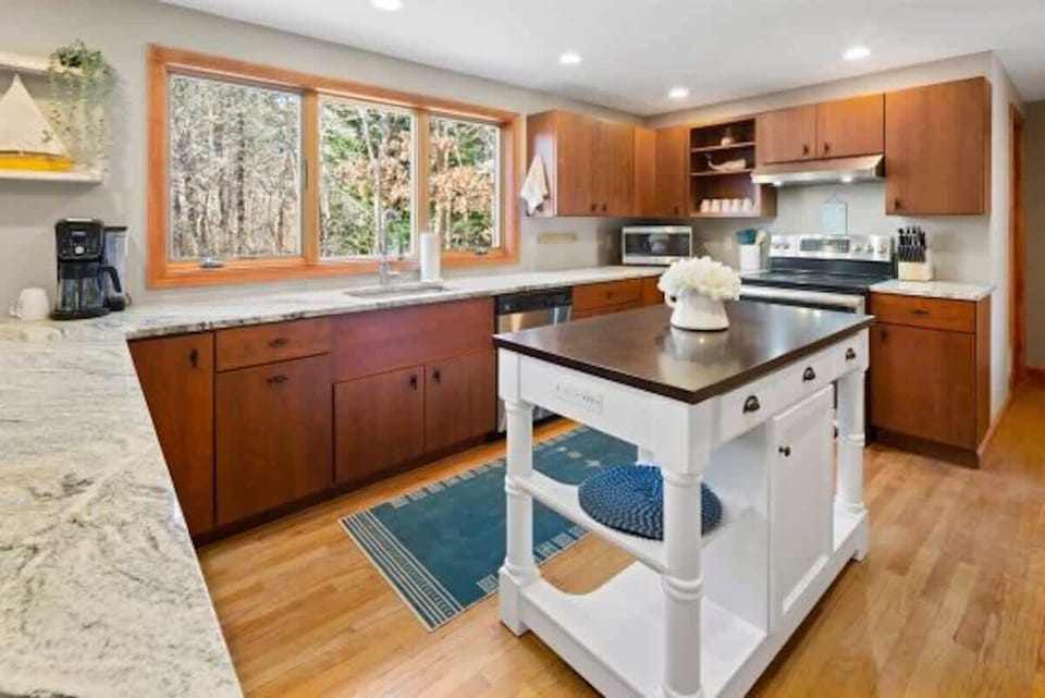 Large kitchen windows showcase beautiful views of the backyard