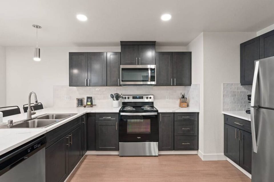 Sleek, fully stocked kitchen with high-end appliances—perfect for home-cooked meals or morning coffee.