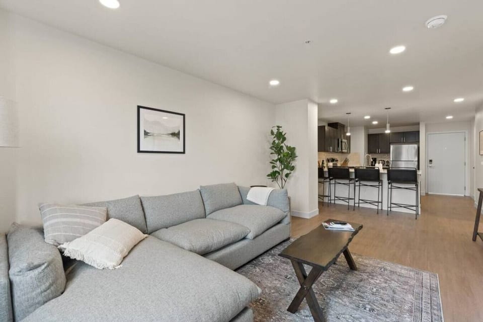Sunlit living space with large windows and an open-concept layout.