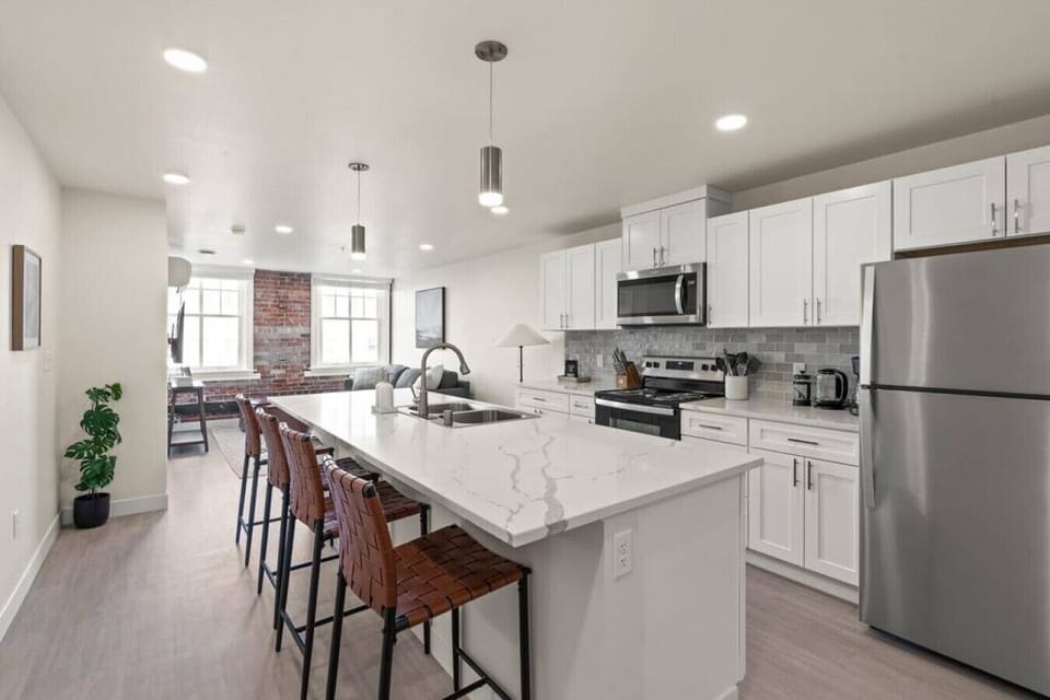 Sleek, fully stocked kitchen with high-end appliances—perfect for home-cooked meals or morning coffee.