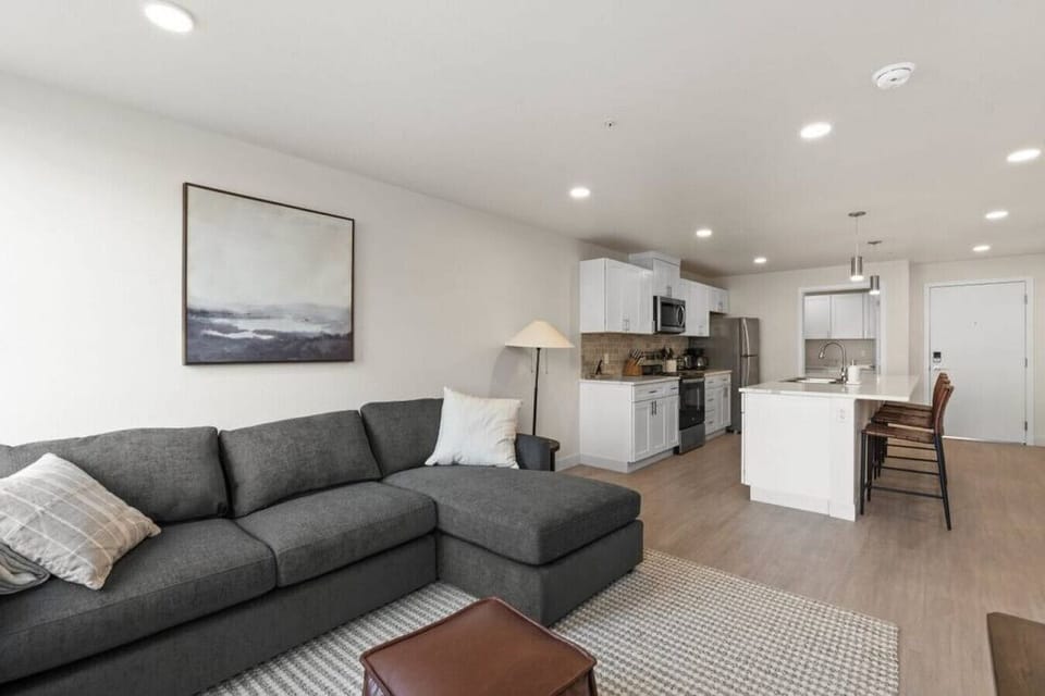 Sunlit living space with large windows and an open-concept layout.