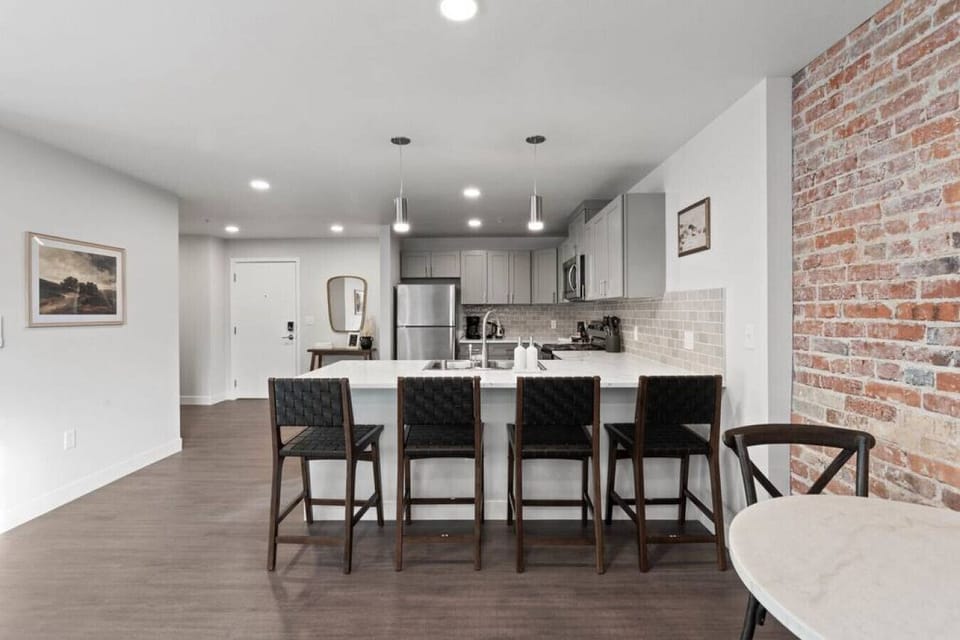 Sleek, fully stocked kitchen with high-end appliances—perfect for home-cooked meals or morning coffee.